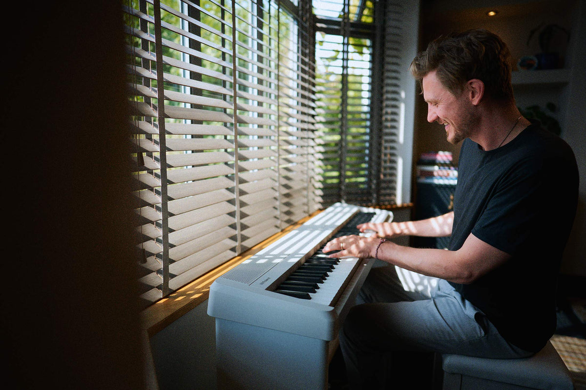 Roland FP-40 white digital piano being played at home