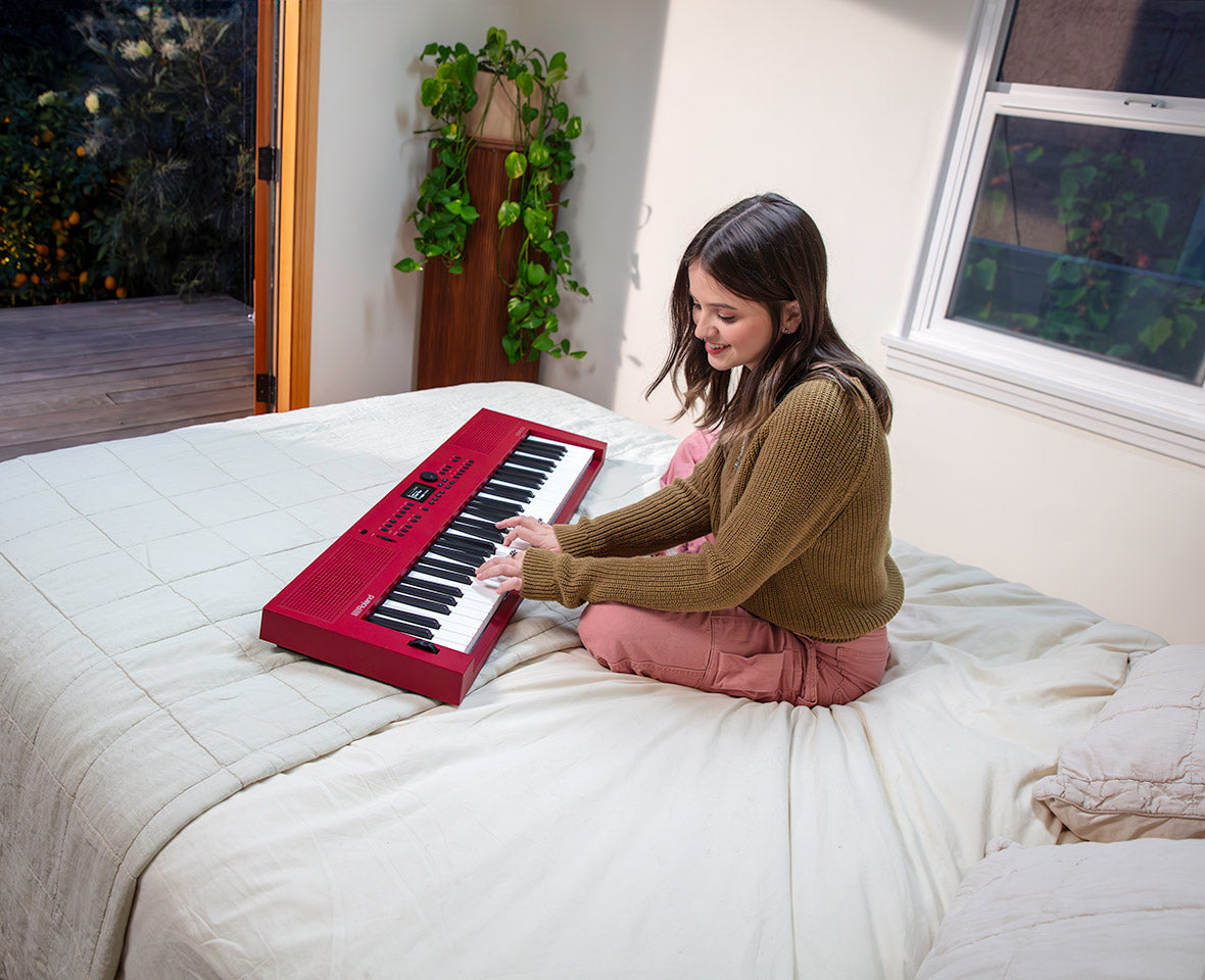 Roland GO:KEYS 3 Dark Red music creation keyboard in a home setting